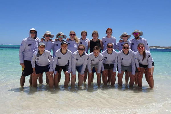 u24 german team of ultimate posing with feet in sea