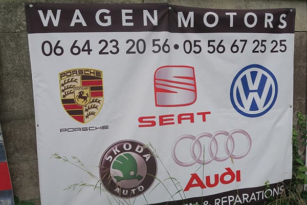 white banner wagen motors on concrete wall