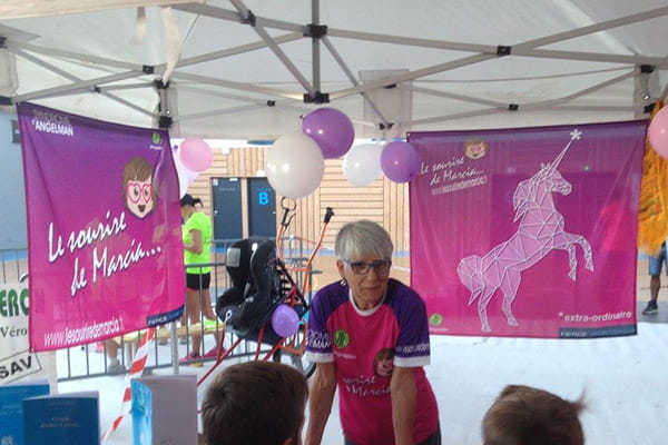 old woman with two pink flags hanging