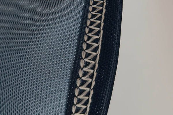 blue textile and white coverlock stitching