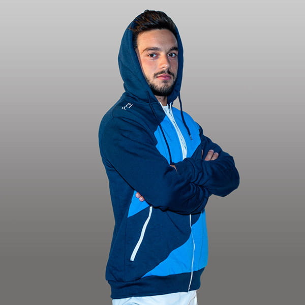 man wearing a dark and light blue stripped hodded vest