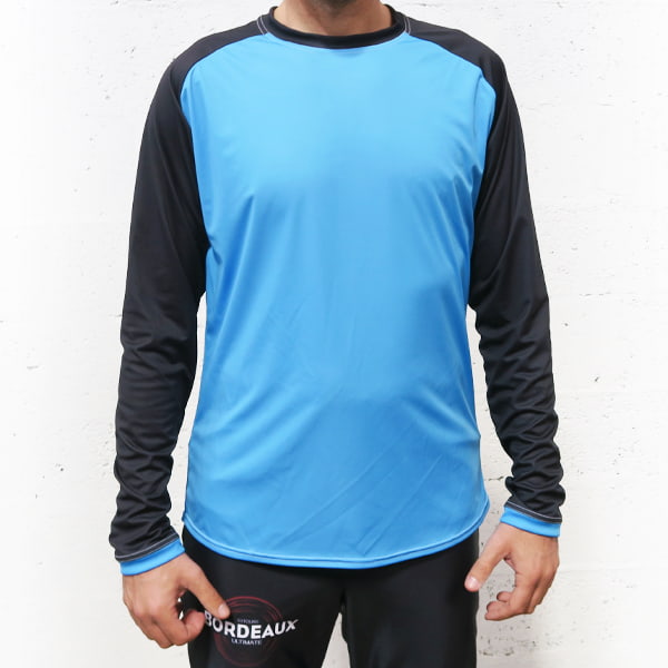 torso of man wearing a blue and black raglan longsleeved jersey