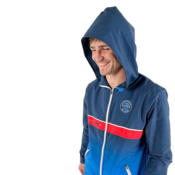 upper body of a smiling man wearing a sublimated blue jacket with a hoodie on