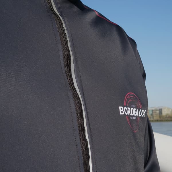 close up on black sport jacket with a reflective zipper