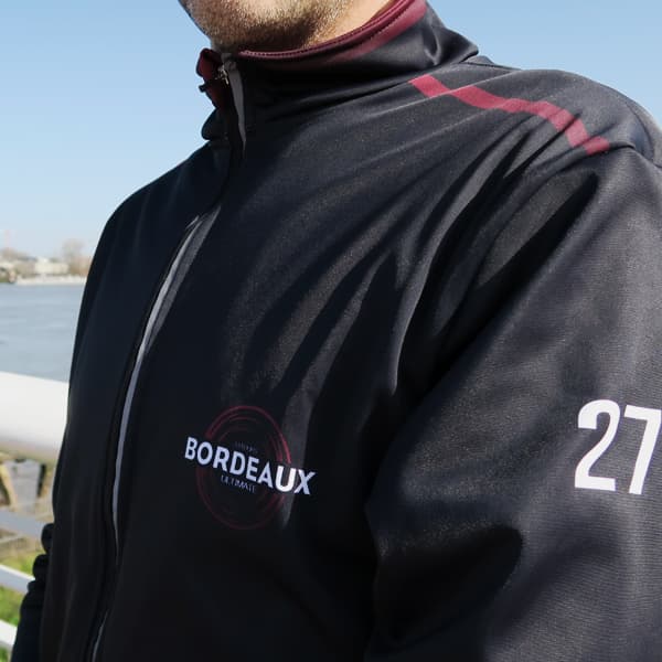 side view of the torso of a man wearing a sport jacketwith number 27