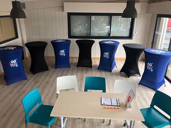 room with blue and black stand up tables